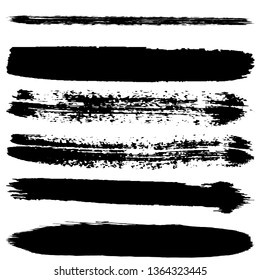 A set of brush strokes of black paint on a white background. Collection of abstract spots