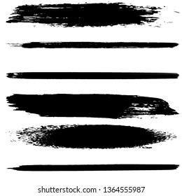 A set of brush strokes of black paint on a white background. Collection of abstract spots