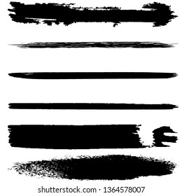 A set of brush strokes of black paint on a white background. Collection of abstract spots