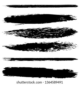 A set of brush strokes of black paint on a white background. Collection of abstract spots