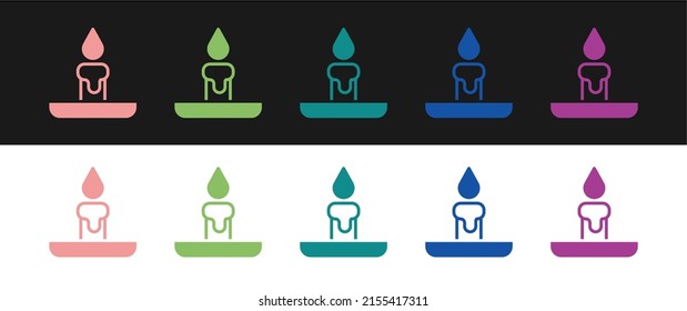 Set Burning candle in candlestick icon isolated on black and white background. Cylindrical candle stick with burning flame.  Vector