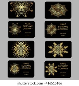 Set of business cards. Gold text on a black background. Mandala, abstract, graphic style, pattern.