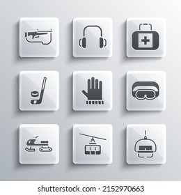 Set Cable car, Ski lift, goggles, Christmas mitten, Snowmobile, Ice hockey stick and puck, Biathlon rifle and First aid kit icon. Vector