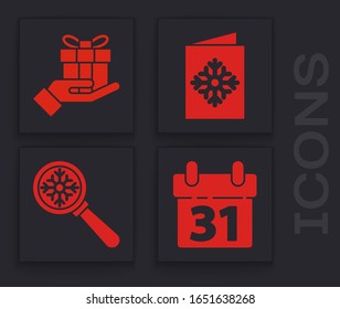 Set Calendar, Gift box in hand, Christmas postcard and Magnifying glass with snowflake icon. Vector