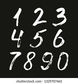 Set of calligraphic numbers painted by white  brush on isolated black background. Lettering for your design. Vector illustration.