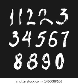 Set of calligraphic numbers painted by white  brush on isolated black background. Lettering for your design. Vector illustration