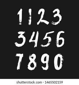 Set of calligraphic numbers painted by white  brush on isolated black background. Lettering for your design. Vector illustration