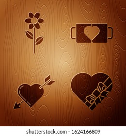 Set Candy in heart shaped box and bow, Flower, Amour symbol with heart and arrow and Two coffee cup and heart on wooden background. Vector