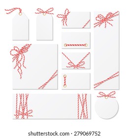 Set of cards, tags and labels tied up with red bakers twine bows and ribbons 