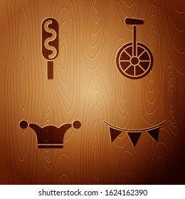 Set Carnival garland with flags, Corn dog, Jester hat with bells and Unicycle or one wheel bicycle on wooden background. Vector