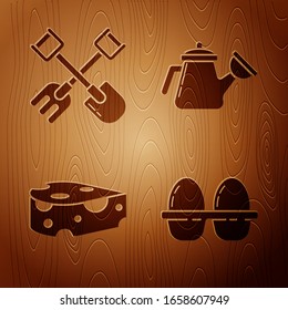 Set Chicken egg in box, Shovel and rake, Cheese and Watering can on wooden background. Vector