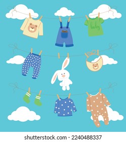 Set of children's clothes on a rope against the sky