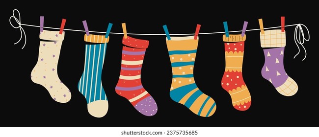 Set of children's socks on a rope with colored clothespins. Vector illustration