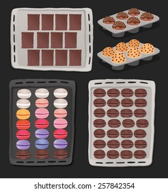 Set of chocolate sweets, cakes and other chocolate foods in trays.