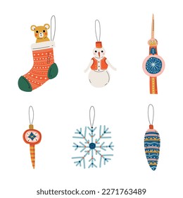Conjunto de baubles de navidad. Sock, copo de nieve, cono, muñeco de nieve para la decoración del árbol de Navidad dibujos animados ilustración del vector