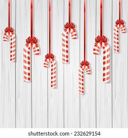 Set of Christmas candy canes with bow on wooden background, illustration.