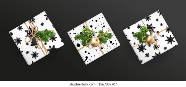 Set of Christmas gift boxes, realistic illustration on black background. Top view. Black and white wrapping paper. Decoration of Christmas toys and Christmas branches. EPS10.