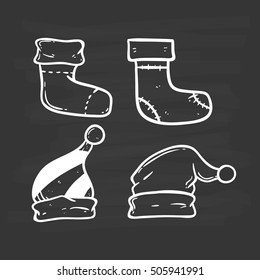 set of christmas hats and socks using doodle art on chalkboard background