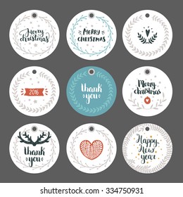 Set of Christmas and New year tags with hand drawn lettering and holiday decoration elements. Xmas gift tags on gray background