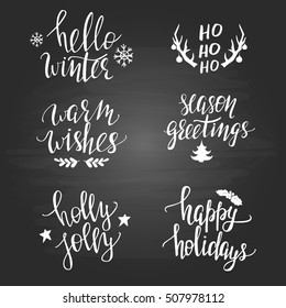 Set of Christmas phrases on the blackboard. Modern hand lettering. 