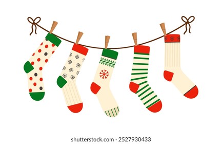 Set of Christmas socks handing on the rope clothesline with clothespins. Various winter socks with different patterns, isolated on a white background. 