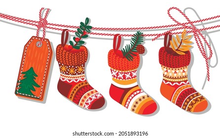 A set of Christmas socks hanging on a string and decorated with pine sprigs with a cone, red berries and leaves.Hand drawn  elements and a tag with a Christmas tree.Vector cartoon illustration.