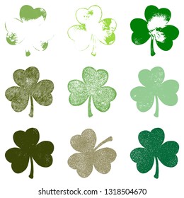 Set of Clover leaf in grunge style isolated on a white background. Distressed Patriks Day shamrock design element collection. Trefoil cutout shabby grainy template. EPS10 vector.