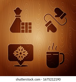 Set Coffee cup, Gift box and bag, Snowflake with speech bubble and Pair of knitted christmas mittens on wooden background. Vector