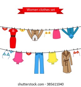 Set of color clothes for the woman on the clothes line. Collection of colorful clothing in a linear style for the woman.  Vector illustration set for your design