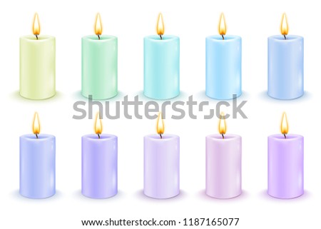 Set of color cylindrical candles with burning flames.
