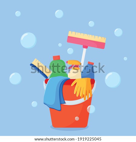 Set of colored cleaning products and accessories in a red bucket on a blue background. Vector illustration of cleaning in flat style.
