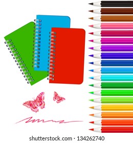 Set of colored pencils with notebooks