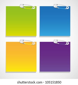 set of colored sheets of paper held together with safety pins