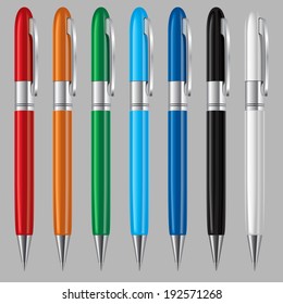 Set of colorful ball point pens on  grey background