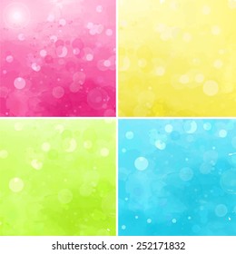 Set of colorful bokeh backgrounds. Bright vector backdrops with lights. Blue, green, yellow and pink.