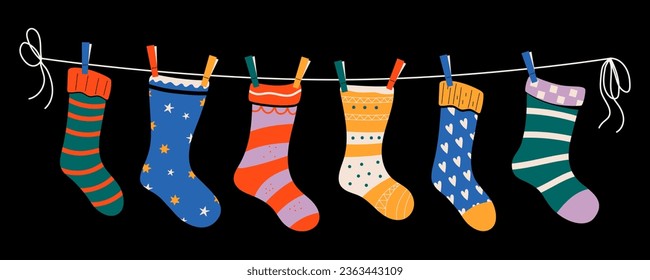 Set of colorful children socks with patterns on a rope with colored clothespins. Vector illustration