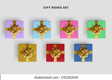 Set of colorful gift boxes with realistic gold bow. Top view.