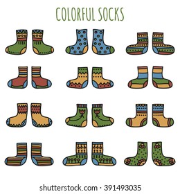 Set of colorful hand drawn socks with different patterns in desaturated colors on a white background. Vector illustration