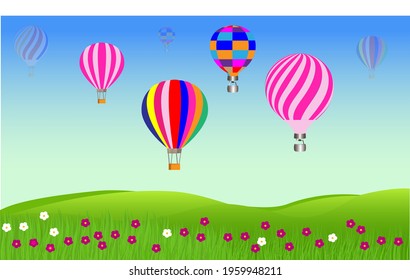 A set of colorful hot air balloons on a green field 