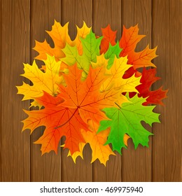 Set of colorful maple leaves on brown wooden background, illustration.