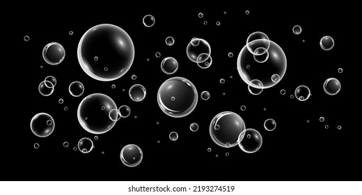 A set of colorful and colorful soap bubbles to create a design. Isolated, transparent, realistic soap bubbles on a black background.

