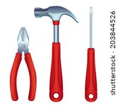 Set of construction tools: a screwdriver, a hammer and a pliers on white background.