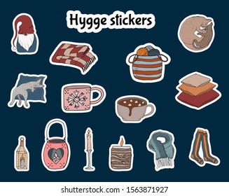 Set cosy vector illustration stickers hygge elements - socks, yarn, scarf, candle, blanket.Isolated on dark background. Scandinavian hygge style.