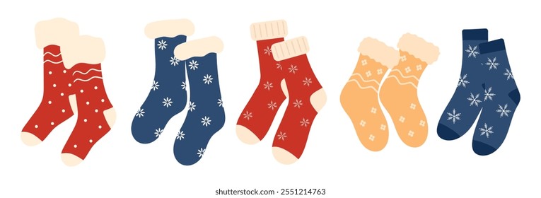 Set of cozy winter Christmas socks, winter shoes with various holiday patterns. Collection of knitted wool and cotton socks with snowflakes isolated on a white background.