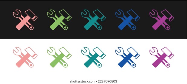 Set Crossed hammer and wrench spanner icon isolated on black and white background. Hardware tools.  Vector