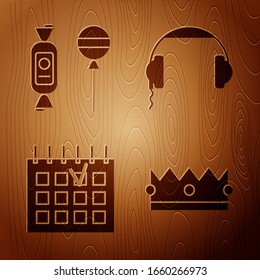 Set Crown , Lollipop , Detailed calendar  and Headphones  on wooden background. Vector