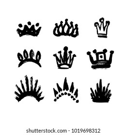 Set of crowns drawn by hand. Set texture strokes thick paint in the form of a crown isolated on white background. Grunge, sketch, graffiti. Isolated black icons, logos, symbols. Vector illustration.