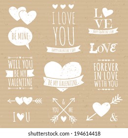 A set of cute design elements in white against cardboard paper background. Perfect for wedding, engagement and Valentine's Day projects.