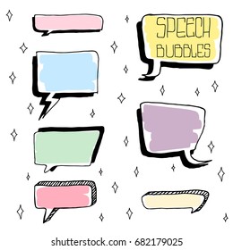 Set of Cute Hand Drawn Speech Bubbles in Doodle Style. Colorful on white sparks background.