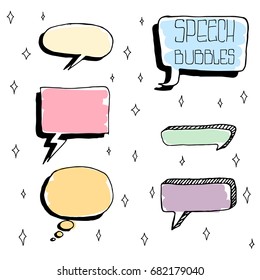 Set of Cute Hand Drawn Speech Bubbles in Doodle Style. Colorful on white sparks background.